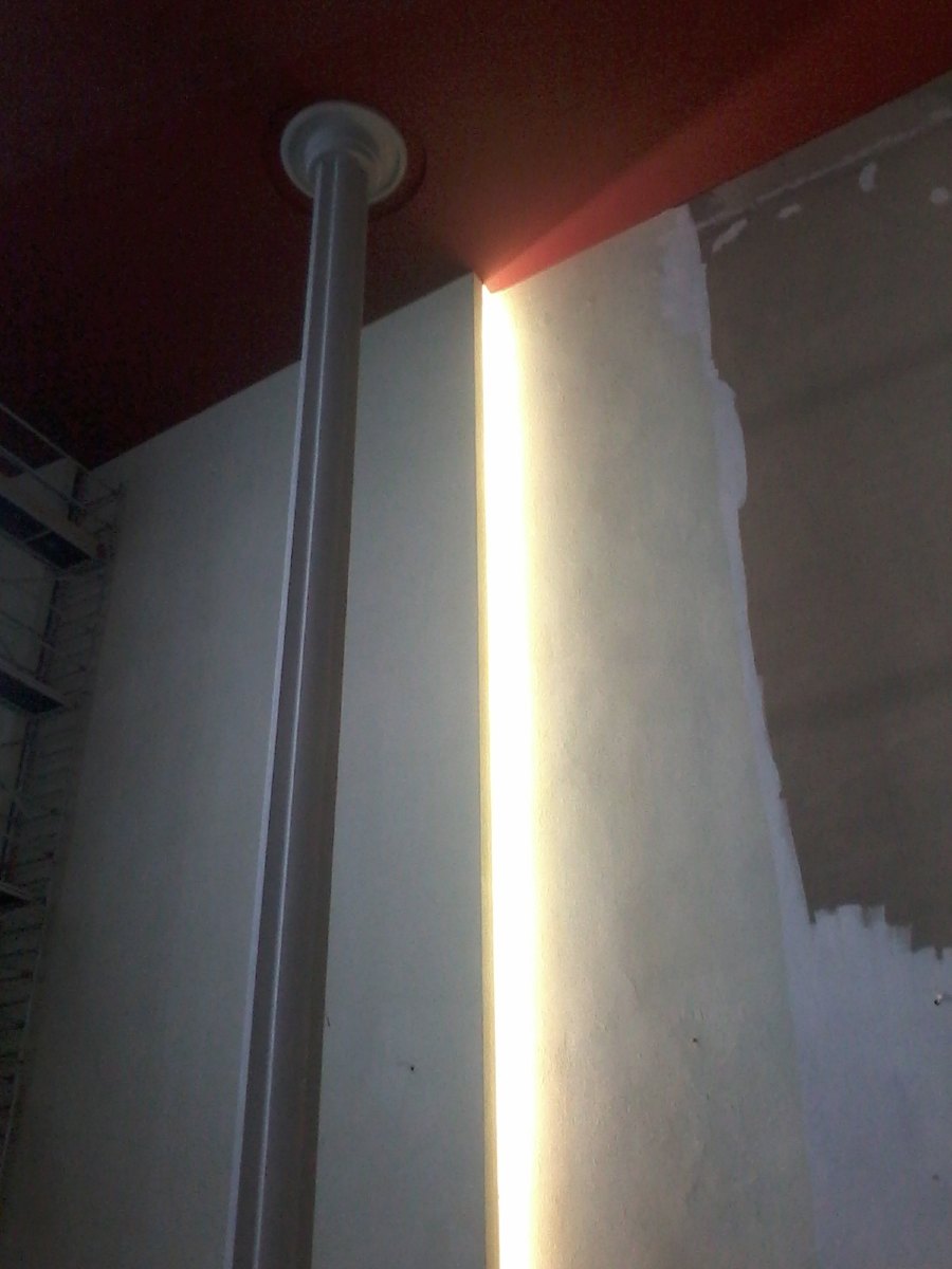 Mise en lumière de la nef. Les "failles", décrochement des murs sont éclairés de haut en bas par des néons