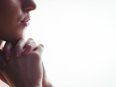 Woman praying with hands together