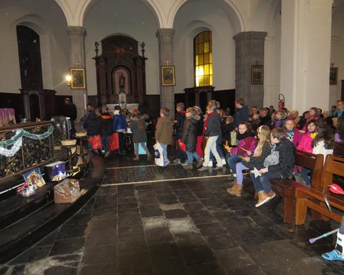 Les enfants déposent des cadeaux au pied de la crèche...
