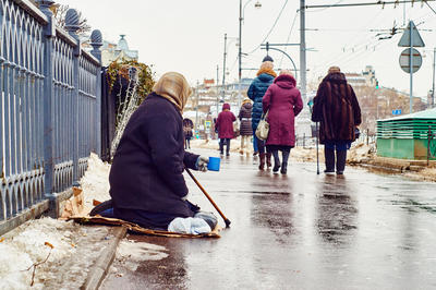 Female beggar asks for money on the Moscow street
