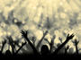 © - fotolia.com Silhouette of people raising hands on a abstract l